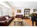 Cozy living room with hardwood floors, large windows, and comfortable leather seating at 9770 Quitman Way, Westminster, CO 80031