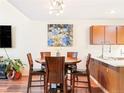 Cozy dining area featuring a round wooden table, modern lighting, and stylish decor at 633 W 114Th Way, Northglenn, CO 80234