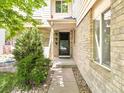 Inviting front entrance with stone details, a well kept yard, and a sturdy front door at 633 W 114Th Way, Northglenn, CO 80234