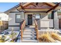 Inviting covered front porch with wooden beams, a wreath, and steps leading to the entrance at 3546 N Garfield St, Denver, CO 80205