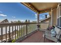 Enjoy outdoor living on this balcony with seating and neighborhood views at 6001 Castlegate Dr # A33, Castle Rock, CO 80108