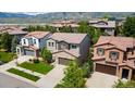 Beautiful two-story home with a stone facade garage, surrounded by lush greenery and neighborhood views at 2347 S Loveland St, Lakewood, CO 80228