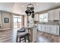 This eat-in kitchen has an island with bar stool seating, granite countertops, and a door to the deck at 10695 Wynspire Rd, Highlands Ranch, CO 80130