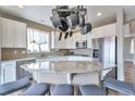 Bright eat-in kitchen with white cabinets, granite countertops, stainless steel appliances, and kitchen island at 10695 Wynspire Rd, Highlands Ranch, CO 80130