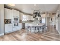 Bright eat-in kitchen with white cabinets, granite countertops, and stainless steel appliances at 10695 Wynspire Rd, Highlands Ranch, CO 80130