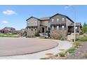 Attractive townhome with stone accents, siding, and a landscaped front yard at 9836 Mount Kataka Pt, Littleton, CO 80125
