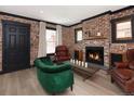 Beautiful living room with brick wall, fireplace, and cozy armchairs at 3731 N Race St, Denver, CO 80205