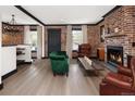 Cozy living room with brick accent walls, fireplace, and hardwood floors at 3731 N Race St, Denver, CO 80205