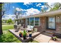 Inviting front porch with comfortable seating, potted plants, and a view of the front yard at 10220 W Montgomery Ave, Littleton, CO 80127