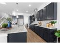 Modern kitchen with white countertops, dark cabinetry, marble backsplash, and stainless steel appliances at 1060 Coal Bank Trl, Castle Rock, CO 80104