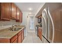 Kitchen with stainless steel appliances, granite counters and wood cabinets at 865 S Quebec St # 103B, Denver, CO 80247