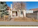 A cozy single-Gathering home with a quaint front porch, classic architectural features, and a small fenced yard at 3135 California St, Denver, CO 80205