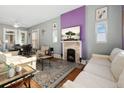 Bright living room features hardwood floors and a decorative fireplace with flatscreen TV at 3135 California St, Denver, CO 80205