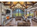 Spacious living room featuring a stone fireplace, vaulted wood ceilings, and panoramic mountain views at 242 Point View Pl, Breckenridge, CO 80424