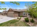 Charming single-Gathering home with stone accents, a two-car garage, and manicured landscaping at 22044 E Jamison Pl, Aurora, CO 80016