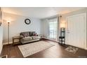 Cozy living room with wood floors, an area rug and a large window at 3358 S Iris Ct, Lakewood, CO 80227