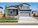 Charming two-story home with stone accents and a well-manicured lawn during daytime at 17487 E 89Th Way, Commerce City, CO 80022