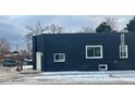 The exterior boasts painted black brick and contrasting white window frames, presenting a modern and bold street presence at 20 E 45Th Ave, Denver, CO 80216