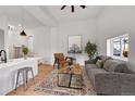 Bright living room featuring modern furnishings, sleek lighting and a stylish accent rug at 20 E 45Th Ave, Denver, CO 80216