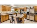 Well-lit kitchen with an island, stainless steel appliances, and plenty of cabinet space at 10168 Granby, Commerce City, CO 80022