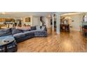 Spacious open-plan living room featuring gleaming hardwood floors and comfortable seating area at 10168 Granby, Commerce City, CO 80022