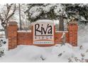 Riva Ridge Apartments community sign covered with snow in front of the building at 539 Wright St # 102, Lakewood, CO 80228