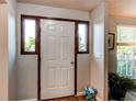 Bright entryway featuring hardwood floors and sidelight windows at 8538 W Glasgow Pl, Littleton, CO 80128