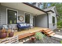 Inviting front porch with seating, wood deck, and decorative accents at 929 Tenderfoot Dr, Larkspur, CO 80118