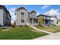 Beautiful two-story home with a well-manicured lawn and inviting curb appeal at 18060 E 106Th Pl, Commerce City, CO 80022