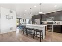 Spacious kitchen features an island with seating, stainless steel appliances, and ample counter space for cooking and entertaining at 18060 E 106Th Pl, Commerce City, CO 80022