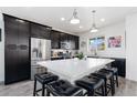 Modern kitchen boasts stainless steel appliances, granite countertops, and an island with seating at 18060 E 106Th Pl, Commerce City, CO 80022