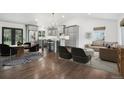 Open-concept living room featuring stylish furnishings and hardwood floors at 7123 S Hudson Cir, Centennial, CO 80122