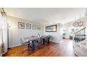 Warm dining room featuring hardwood floors, and stairway to the second level at 5436 S Versailles Way, Aurora, CO 80015