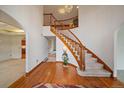 Bright foyer with hardwood floors, curved staircase, and elegant chandelier at 7914 S Clayton Cir, Centennial, CO 80122