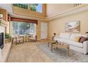 Bright and airy living room with high ceilings and large windows, offering plenty of natural light at 1446 Braewood Ave, Highlands Ranch, CO 80129