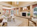 Spacious living room featuring a cozy fireplace and neutral decor with access to the outdoor patio at 1446 Braewood Ave, Highlands Ranch, CO 80129