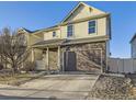Inviting two-story home with stone accents, neutral siding, and an attached two-car garage at 18241 E 47Th Dr, Denver, CO 80249