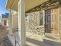 Detailed front entrance showcasing the stone facade, covered porch, and the front door at 18241 E 47Th Dr, Denver, CO 80249