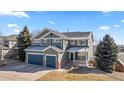 Beautiful two-story home with a three-car garage, a quaint porch and mature trees in a well manicured yard at 1929 Baguette Dr, Castle Rock, CO 80108