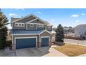 Charming two-story home with a three-car garage, quaint porch, and easy access to walking and biking trails at 1929 Baguette Dr, Castle Rock, CO 80108