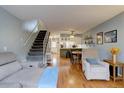 Open floorplan featuring hardwood floors, stairs, and a comfortable living area at 14211 E Hawaii Cir # A, Aurora, CO 80012