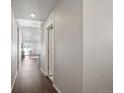 Bright hallway with hardwood floors leading to living room at 507 Bonneville Ave, Fort Lupton, CO 80621