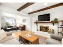 Spacious living room featuring a fireplace, hardwood floors, and ample natural light at 10618 W Layton Pl, Littleton, CO 80127