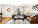 Cozy living room with a large bay window offering plenty of natural light at 10618 W Layton Pl, Littleton, CO 80127