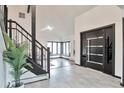 Bright foyer with stylish door and staircase, offering a welcoming entrance at 4853 S Crystal St, Aurora, CO 80015