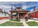 Charming brick home with a cozy front porch, manicured lawn, and inviting curb appeal at 2421 W 38Th Ave, Denver, CO 80211