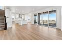 Bright, open-concept living space with hardwood floors and sliding doors to a covered balcony at 8950 Whiteclover St, Littleton, CO 80125