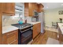 This kitchen offers stainless steel appliances, wood cabinets, tiled backsplash and wood floors at 2665 S Pennsylvania St, Denver, CO 80210