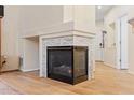Stylish corner fireplace with stone surround and wooden flooring, enhancing the living room's ambiance at 3000 E 112 Ave # 102, Northglenn, CO 80233