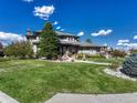 Landscaped lawn and two-story house with a spacious yard at 9562 Silent Hills Ln, Lone Tree, CO 80124